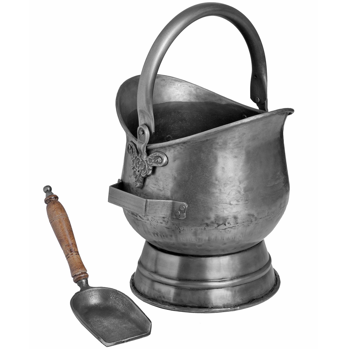 Antique pewter coal bucket with intricate floral embossing and a curved handle, accompanied by a wooden-handled shovel.