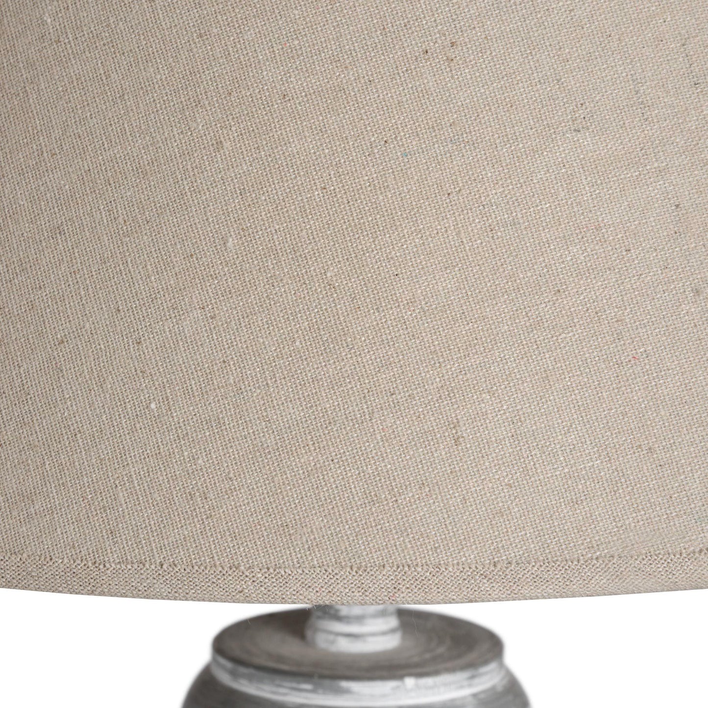 Grey and whitewashed floor lamp featuring a classic linen shade, showcasing intricate handcrafted detailing for an elegant ambiance.