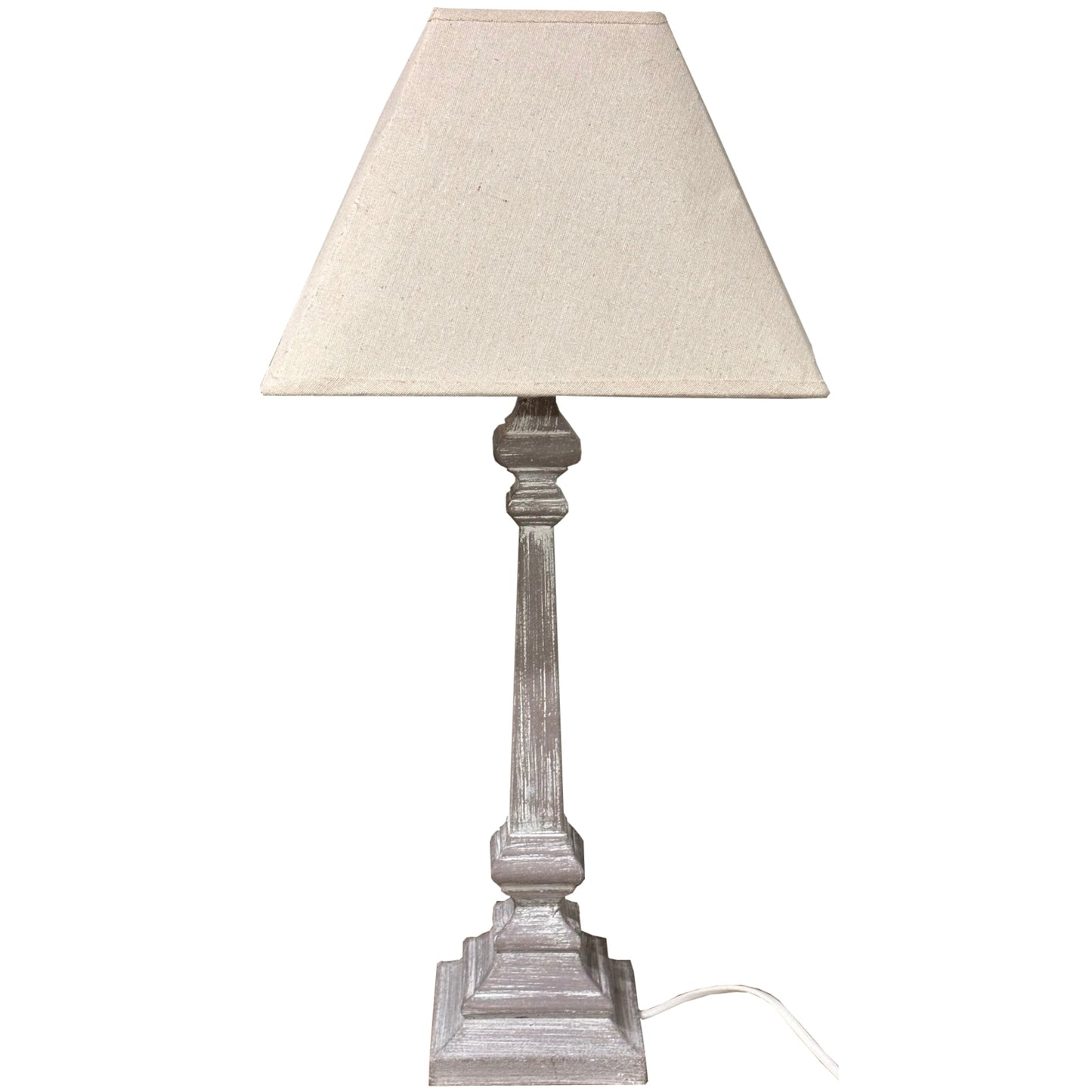 Elegant table lamp with a whitewashed wooden base and soft linen shade, perfect for creating a cozy atmosphere in rustic interiors.