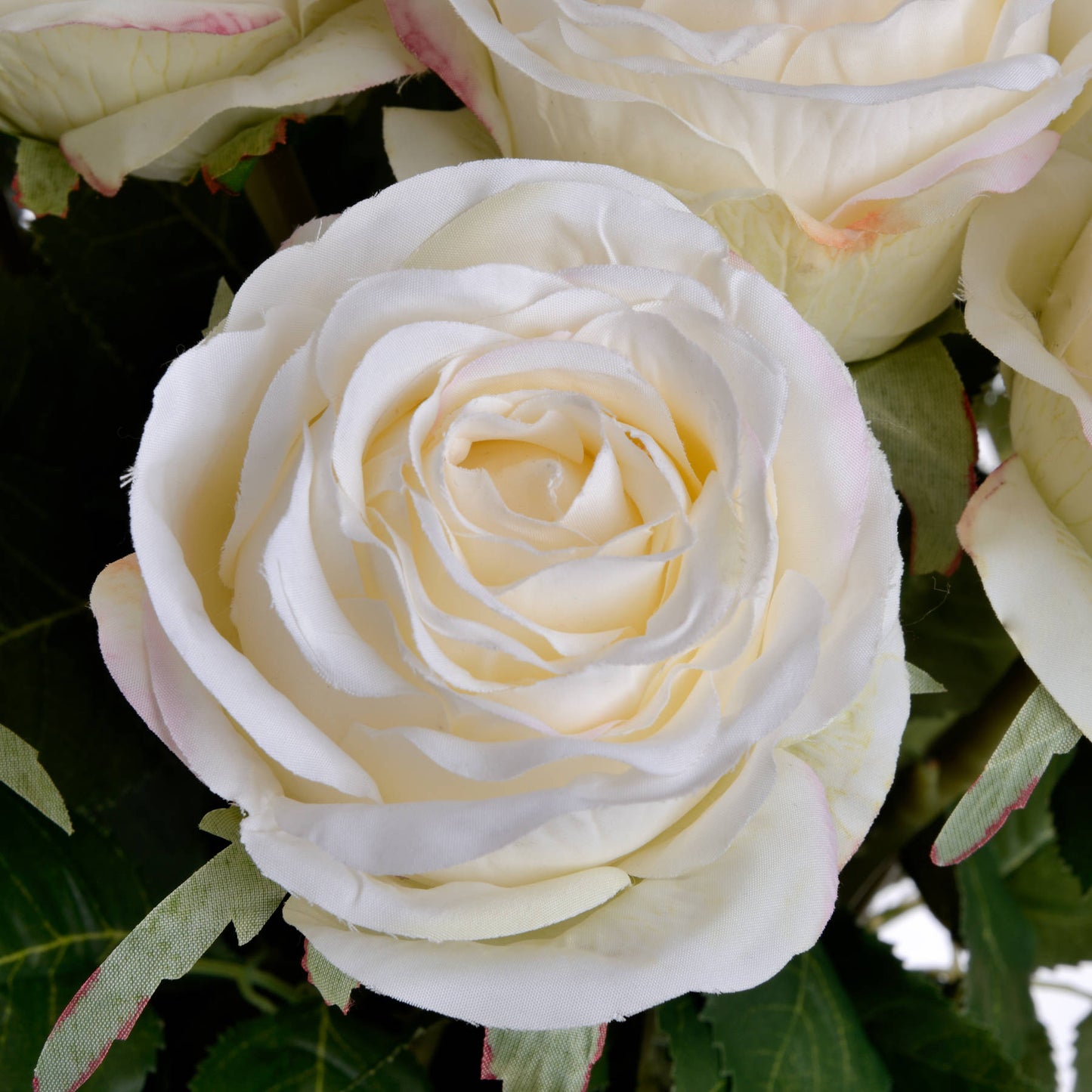 Realistic artificial white rose with intricate petal detailing, set against lush green leaves, perfect for elegant decor.