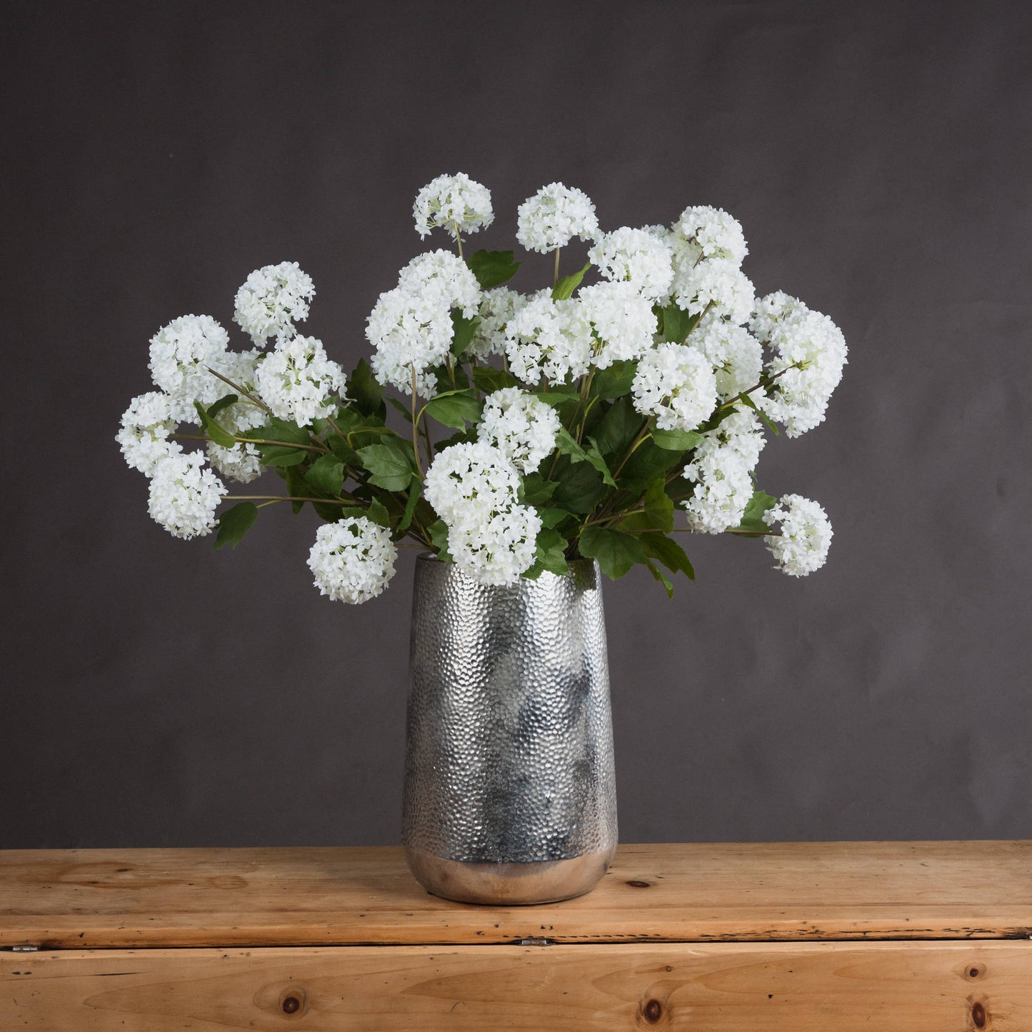 Lifelike white viburnum flowers in a silver textured vase, complementing modern and traditional decor with natural elegance.