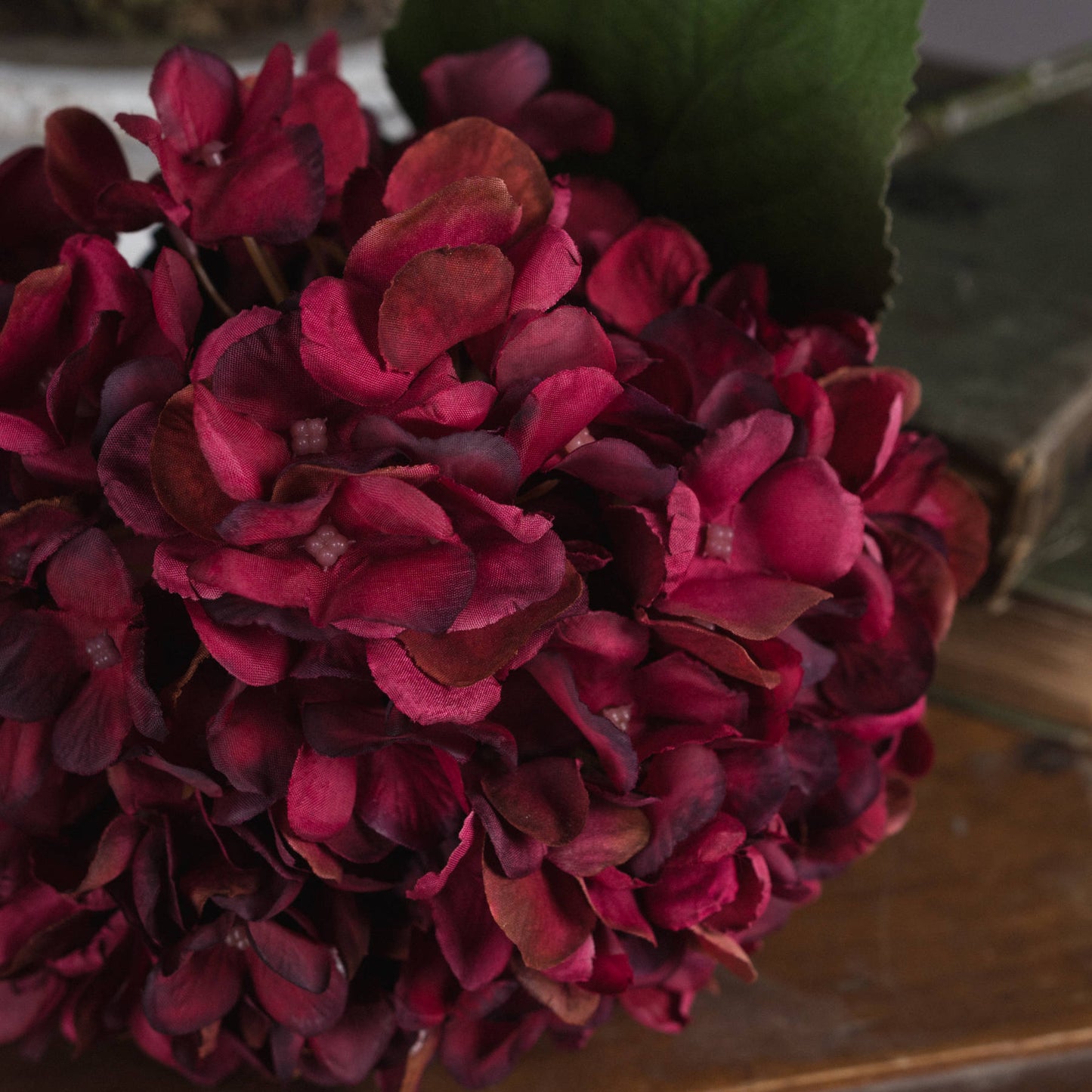 Lifelike autumn ruby hydrangea with deep red petals and rich textures, perfect for enhancing any elegant decor.