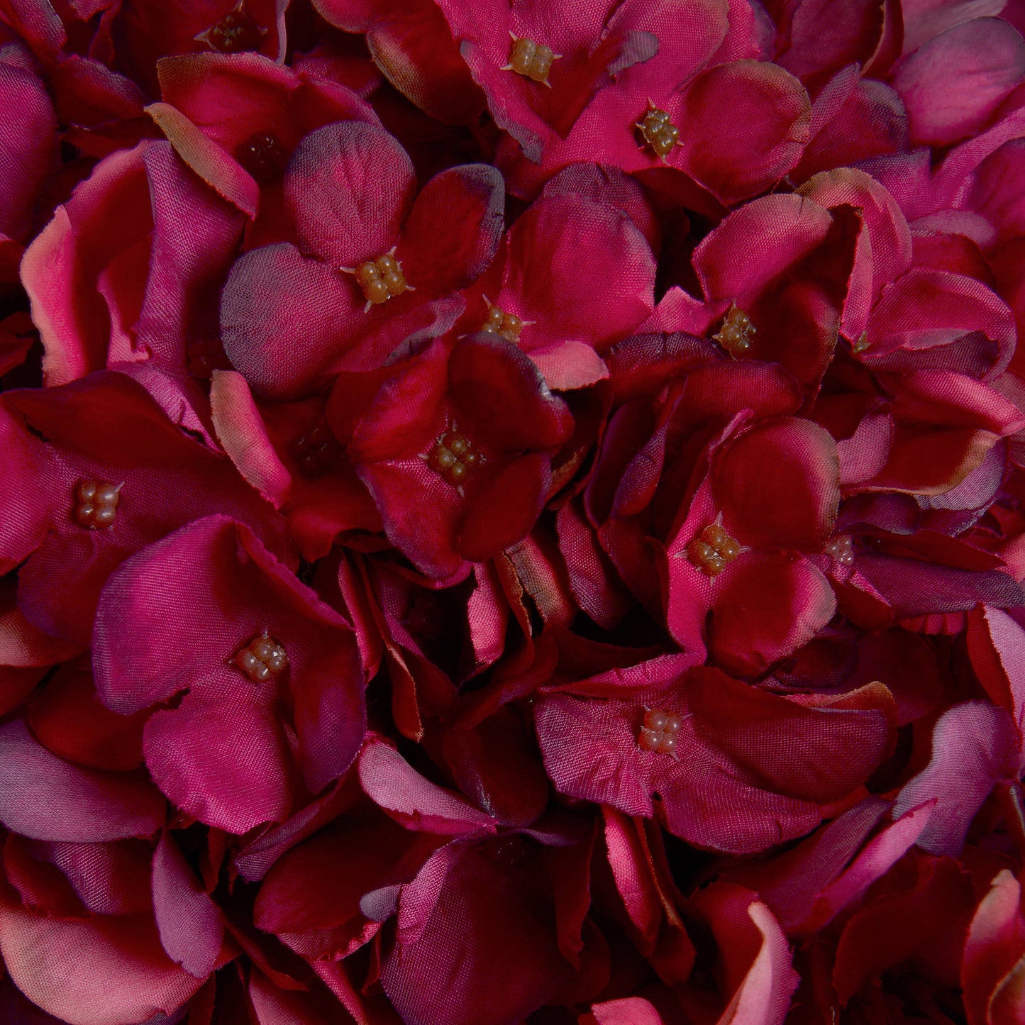 Richly detailed, deep ruby artificial hydrangea petals create a warm, sophisticated autumn accent for decor.