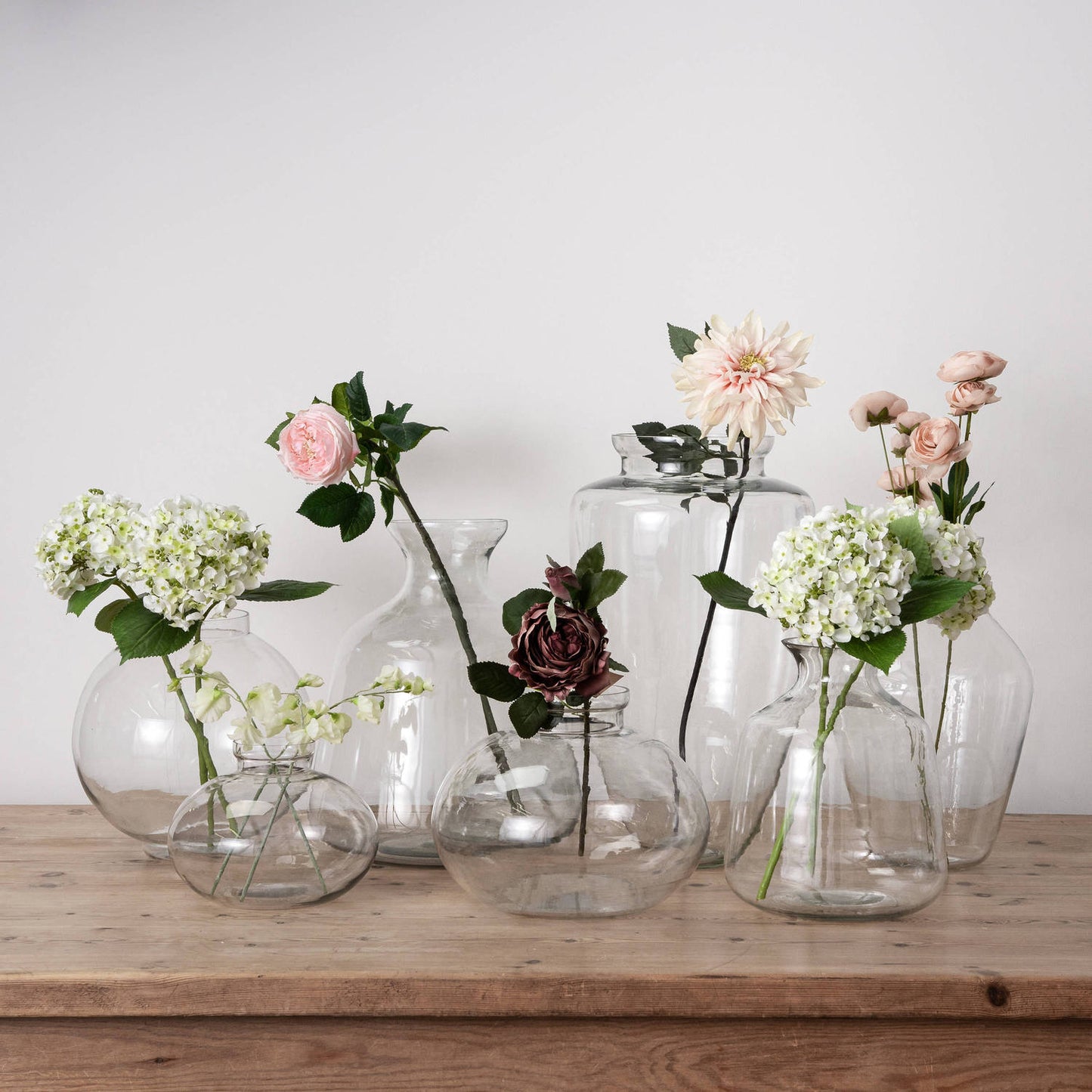 Red Hydria glass vase, featuring a distinctive shape and high-quality glass, enhances decor with elegant flowers or stands alone.