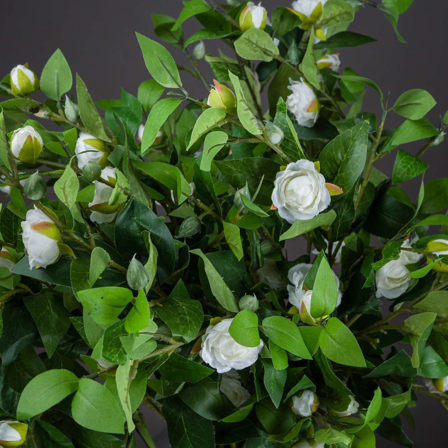 Cream gardenia stem featuring delicate cream petals and lush green leaves, ideal for elegant floral arrangements.