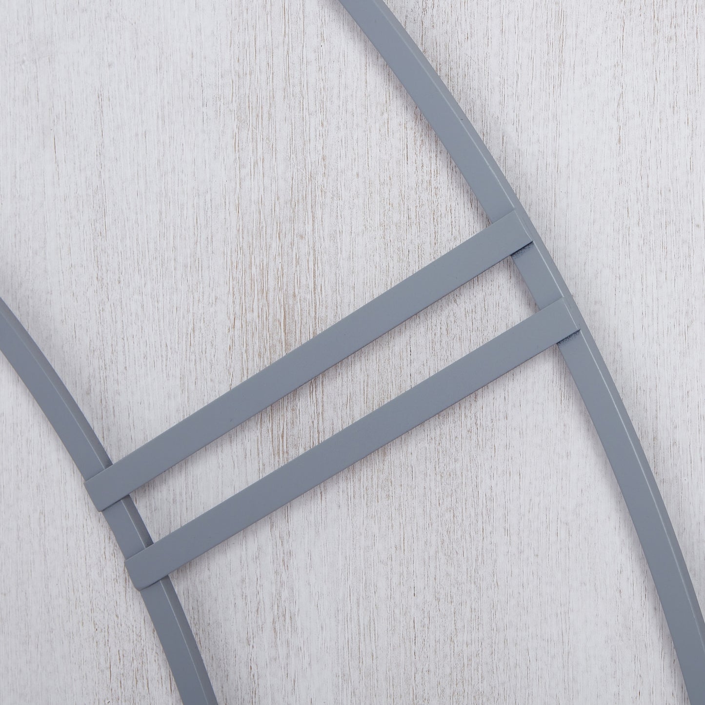 Multi-paneled wall clock with a sleek gray finish, featuring a modern design that adds elegance to any space.