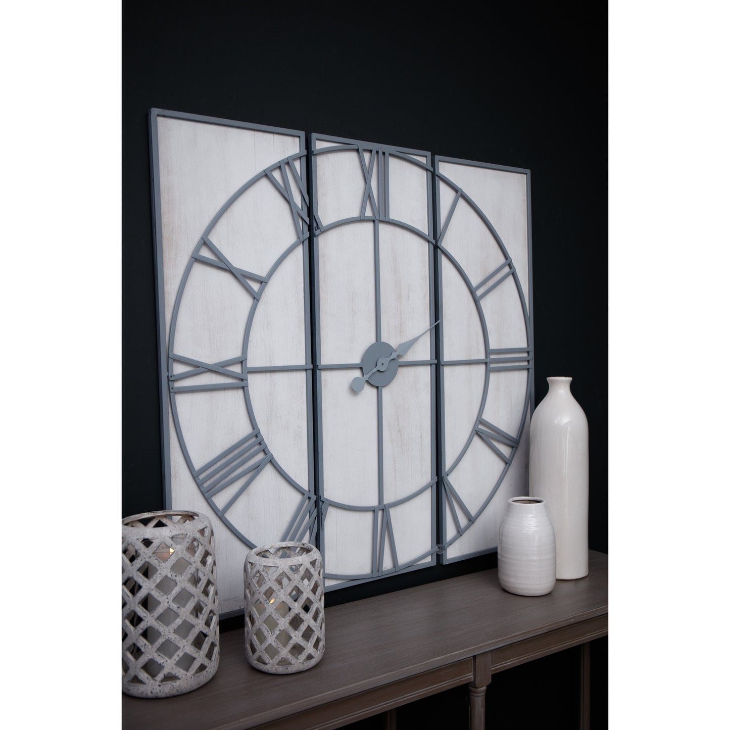 Multi-paneled wall clock features a sleek gray frame with Roman numerals on a white wood background, enhancing any decor.