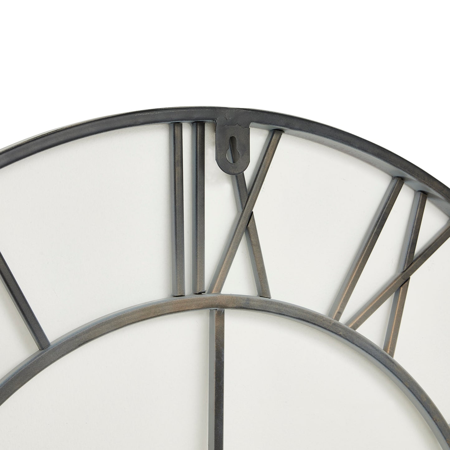 Oversized grey skeleton wall clock with elegant Roman numerals, minimalist metal design, creating captivating shadows for modern interiors.