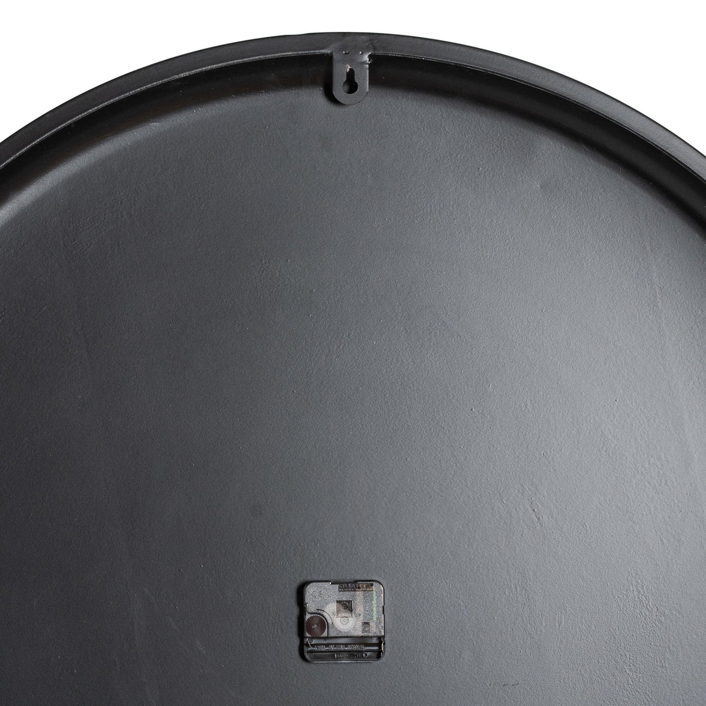 Black back of the Rothay Large Wall Clock, featuring a battery compartment and hanging hook, showcasing a smooth surface design.