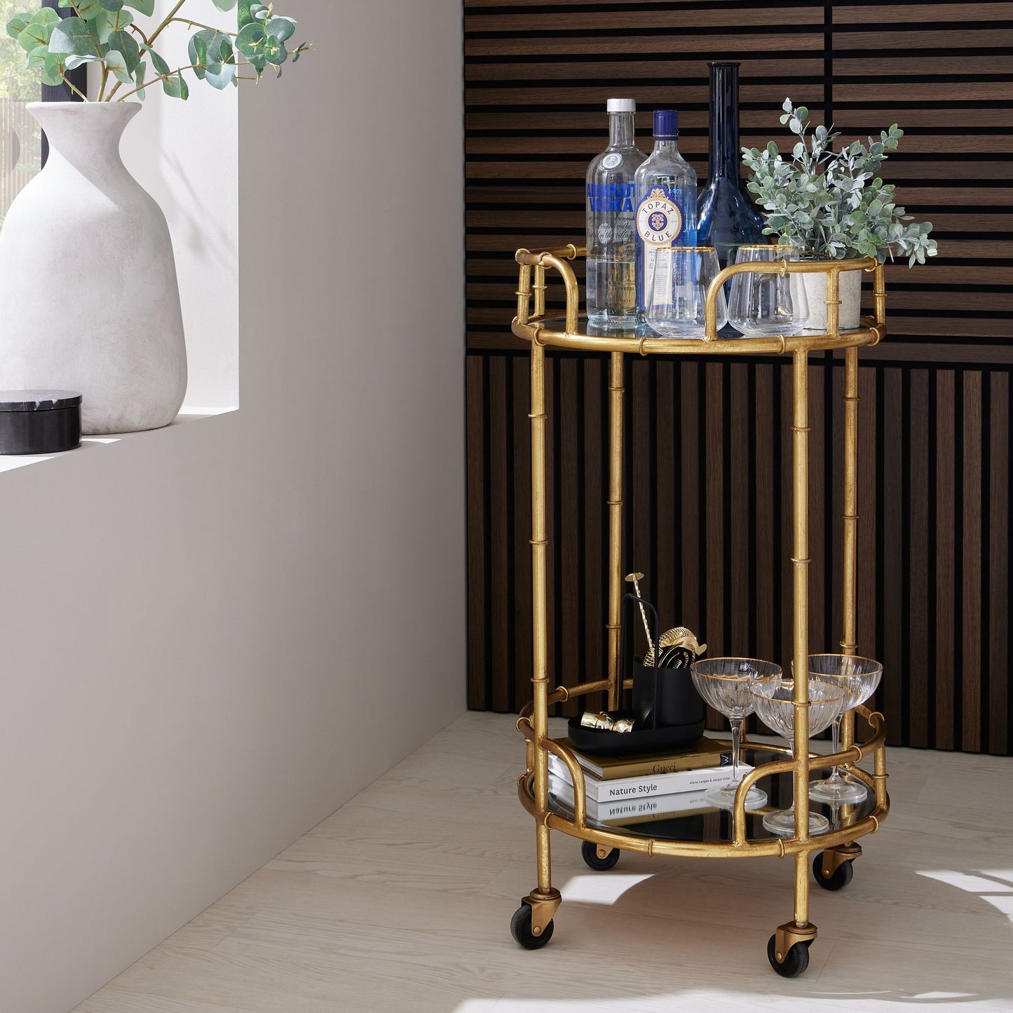Artificial eucalyptus arranged in a sleek stone effect pot, adding visual elegance to a stylish space.