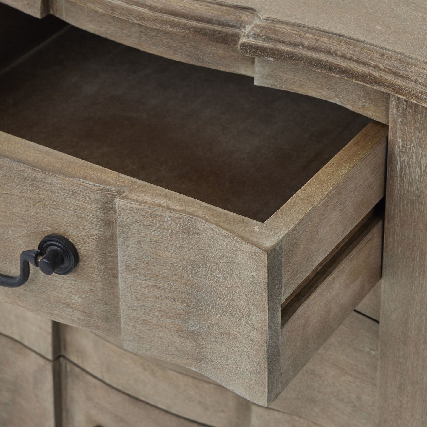 Red bedside table with classic French-inspired design, featuring black ironwork handles and a washed, bleached hardwood finish.