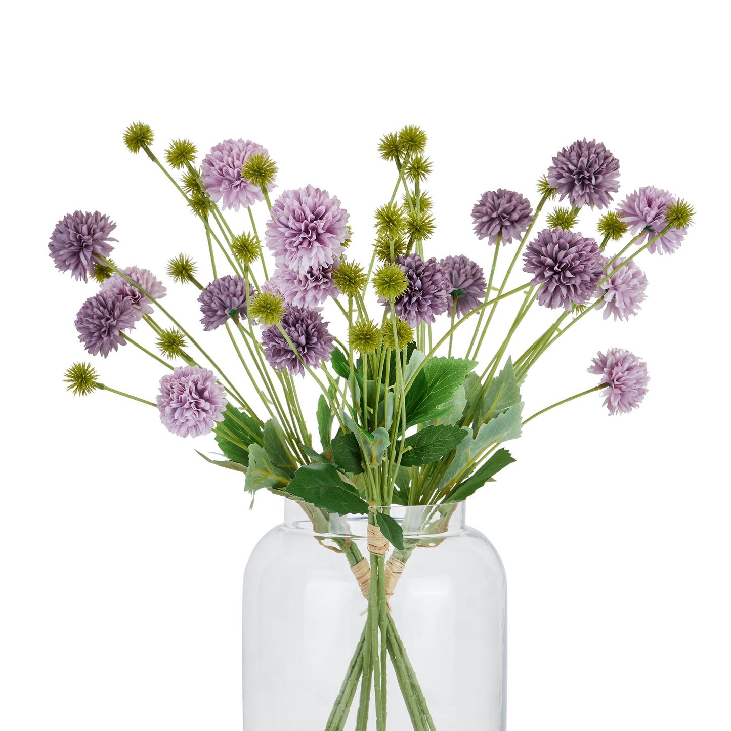 A bouquet of deep purple chrysanthemums with layered petals and green foliage, elegantly arranged in a clear glass vase.