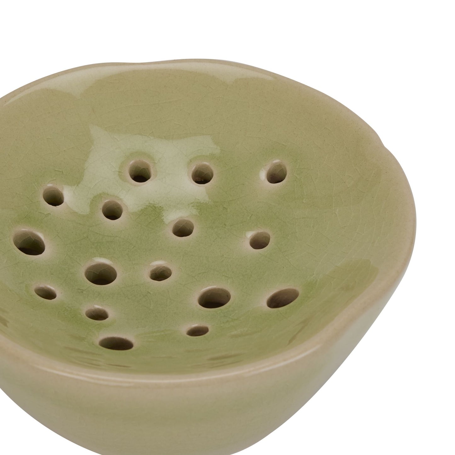 Light green ceramic flower frog with a glossy finish and multiple holes, designed for stable floral displays and elegant decor.