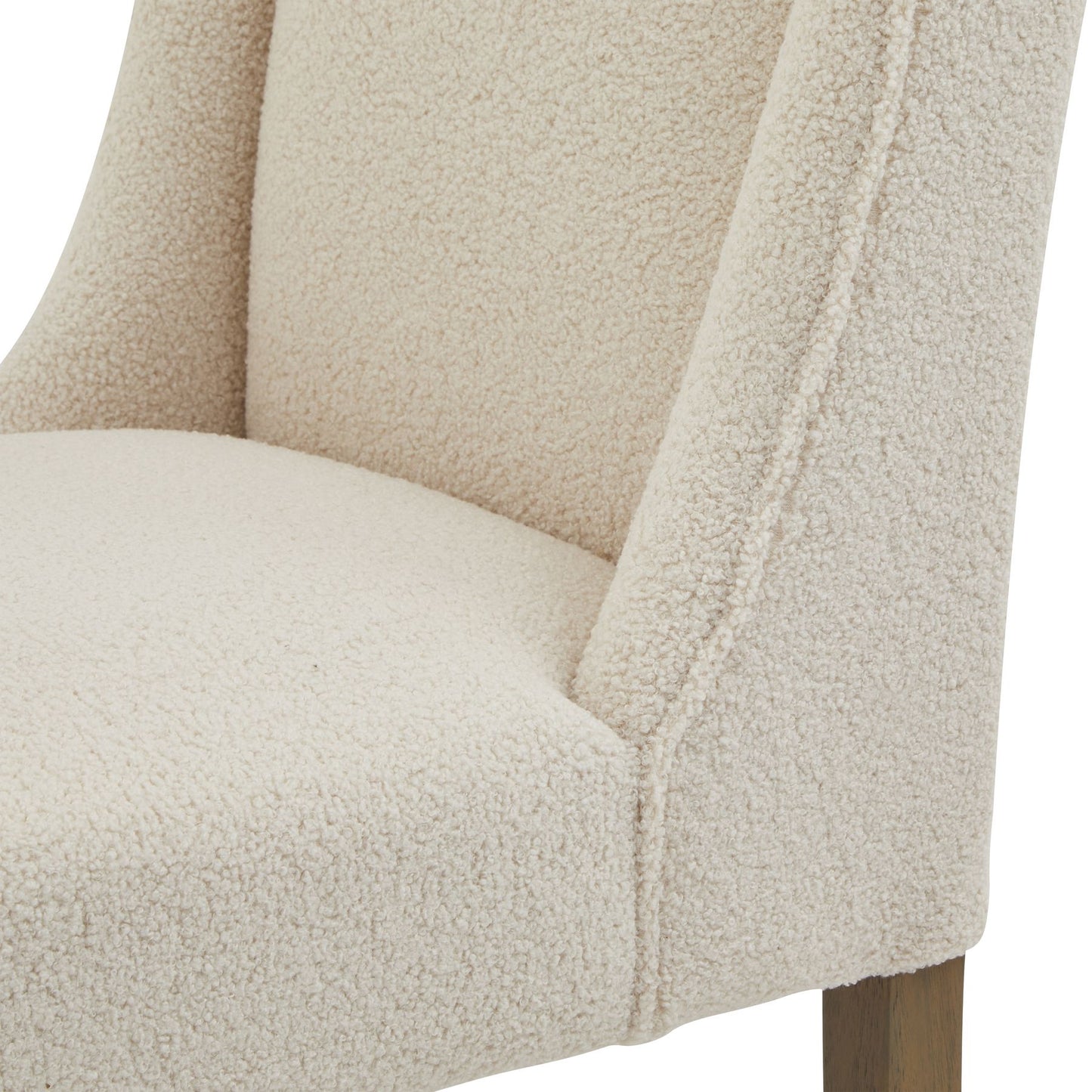 Cream boucle upholstery on a sleek dining chair with a durable rubberwood frame, perfect for elegant dining spaces.
