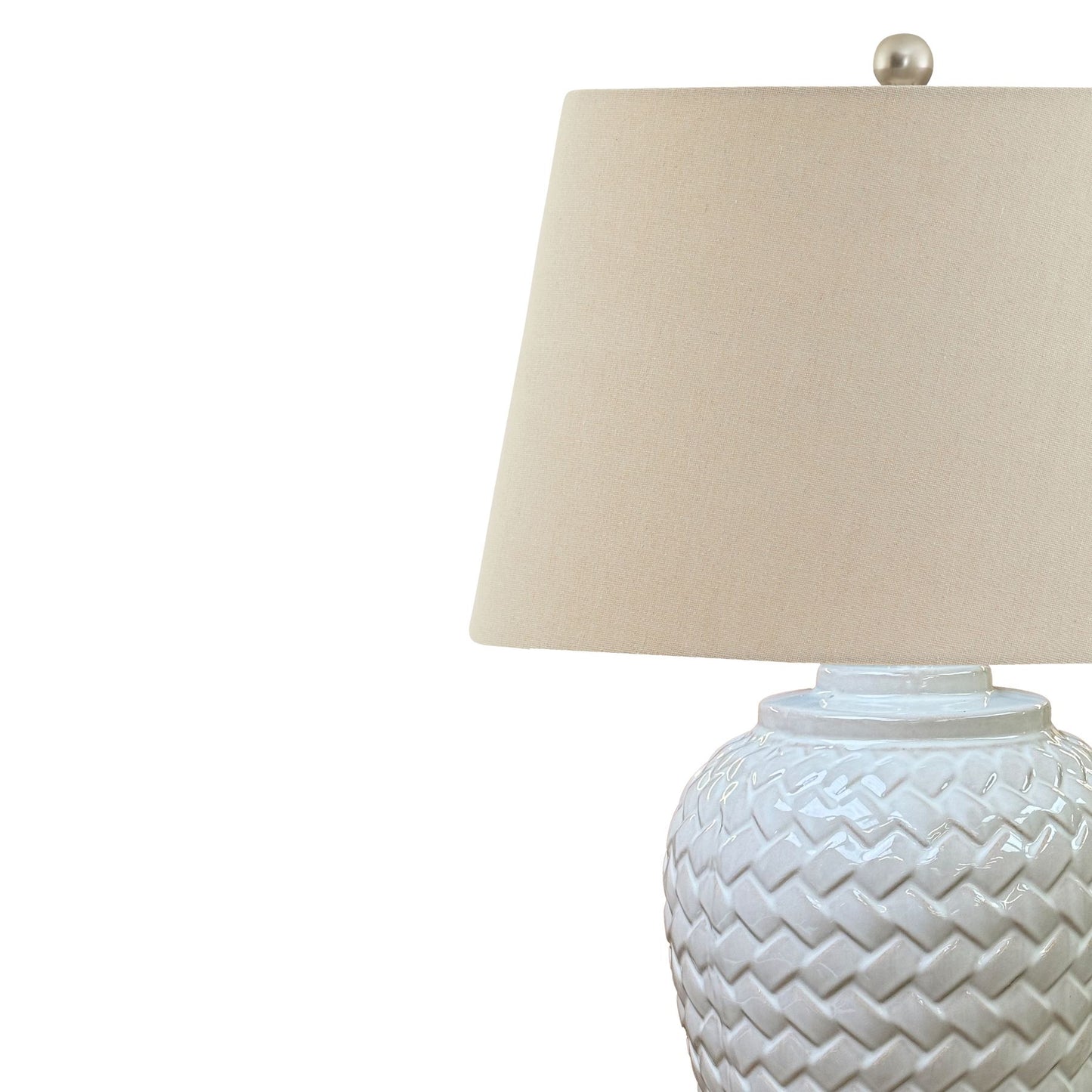 Woven ceramic table lamp with white chevron pattern and a soft linen shade, providing elegant illumination for any space.