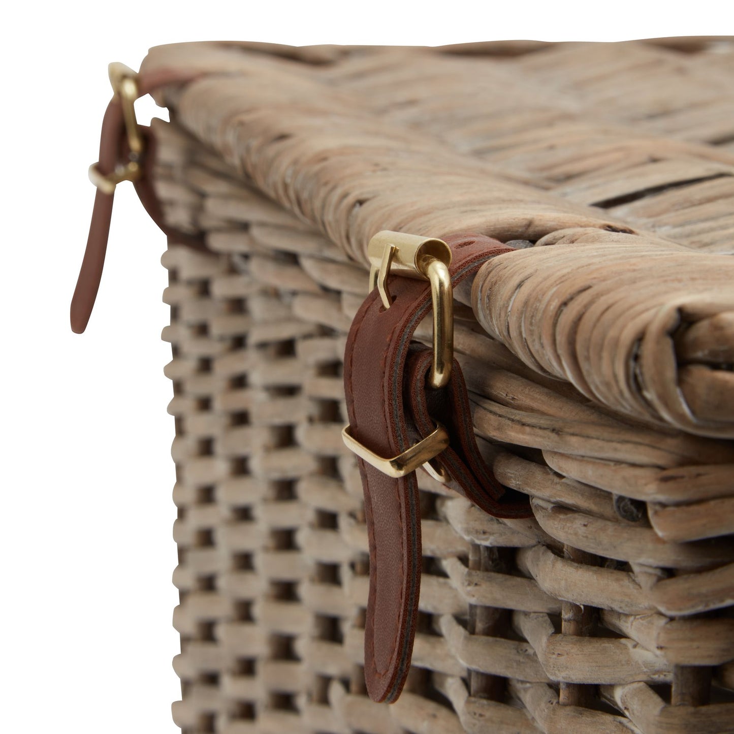 Coastal-inspired wicker hamper basket with intricate weaving, featuring leather straps and gold buckles for elegant storage.