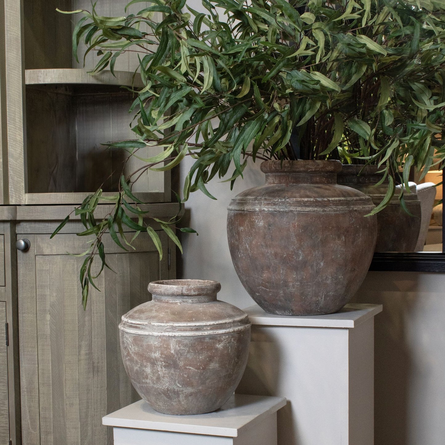 Distressed brown Siena Water Pot showcases a classic urn shape, perfect for vibrant greenery or as a stylish decor piece.
