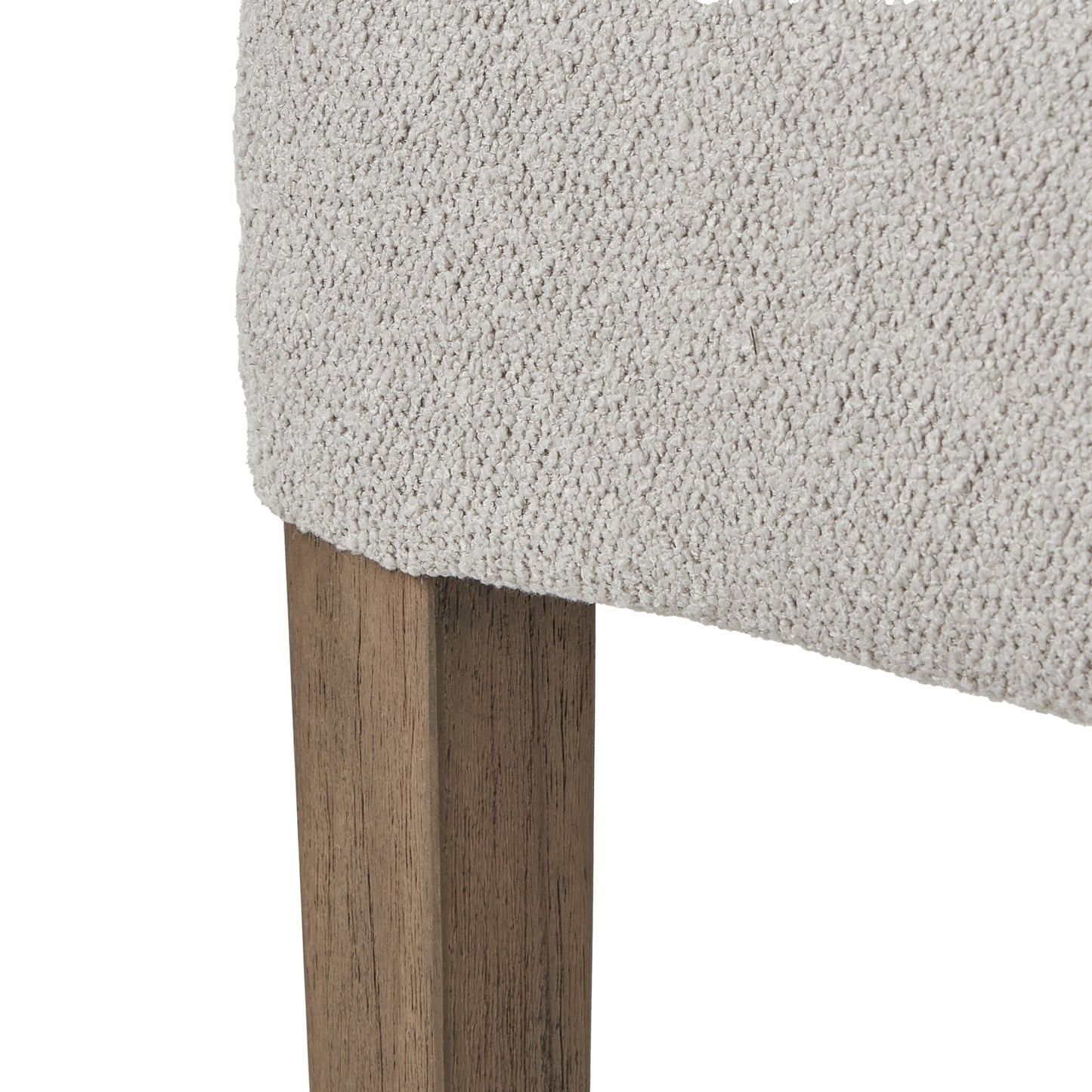 Plush neutral twill upholstery atop a sturdy, rustic wooden frame, featuring a curved backrest and sloped armrests for elegance.