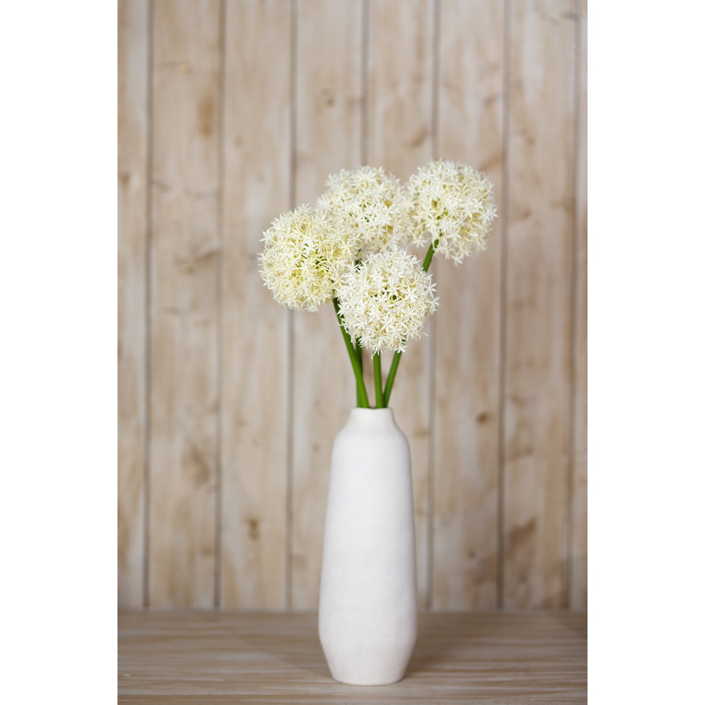 Cream artificial Allium stem with a cluster of delicate white flowers on slender green stems, displayed in a simple white vase.