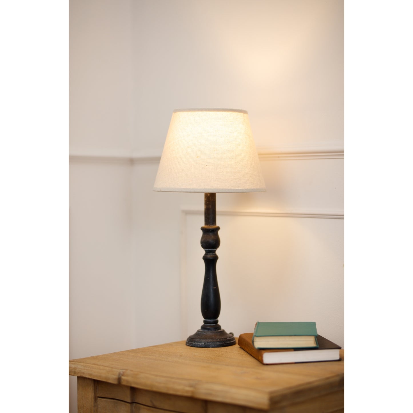 Ravenna Column Table Lamp features a distressed black base and a neutral linen shade, enhancing modern and farmhouse decor.