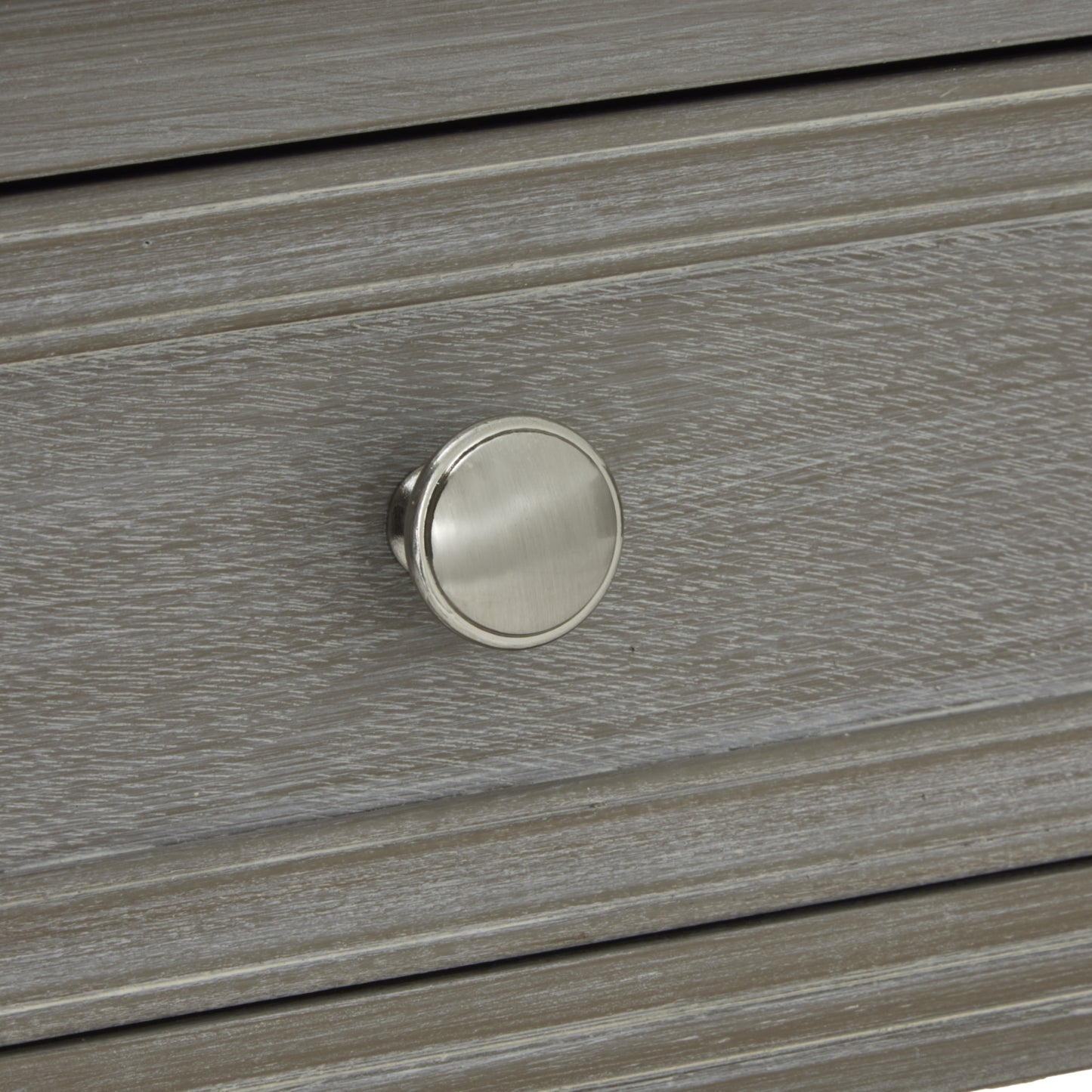 Close-up of a light gray console table drawer featuring a sleek, round, brushed nickel knob, showcasing refined craftsmanship.