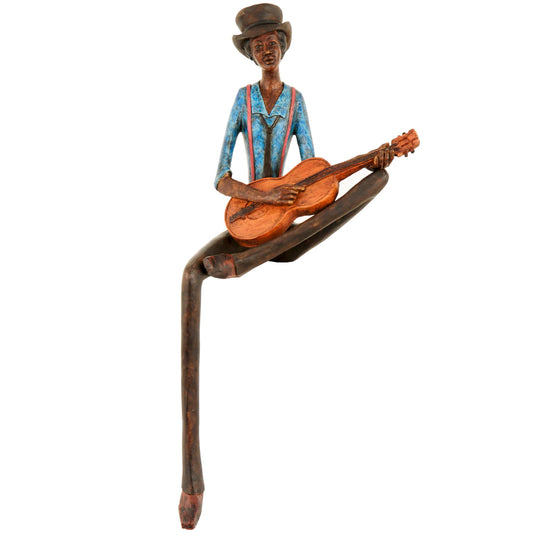 Sitting jazz figurine in vibrant blue and brown, elegantly playing a guitar, features a unique leg design for edge seating.