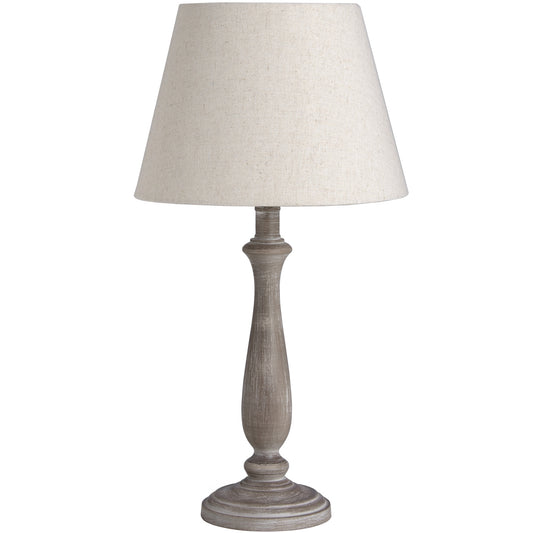 Elegant table lamp with a rustic wooden base in a whitewash finish and a creamy linen shade, perfect for cozy interiors.