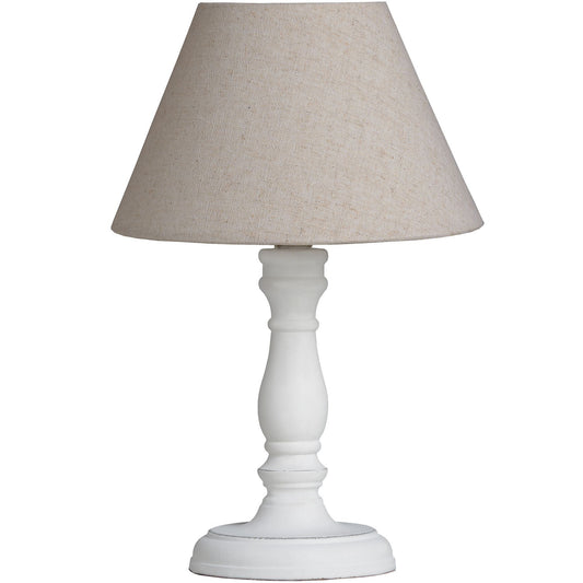 White table lamp with a textured base and oatmeal shade, offering warm ambient lighting for a cozy and elegant atmosphere.