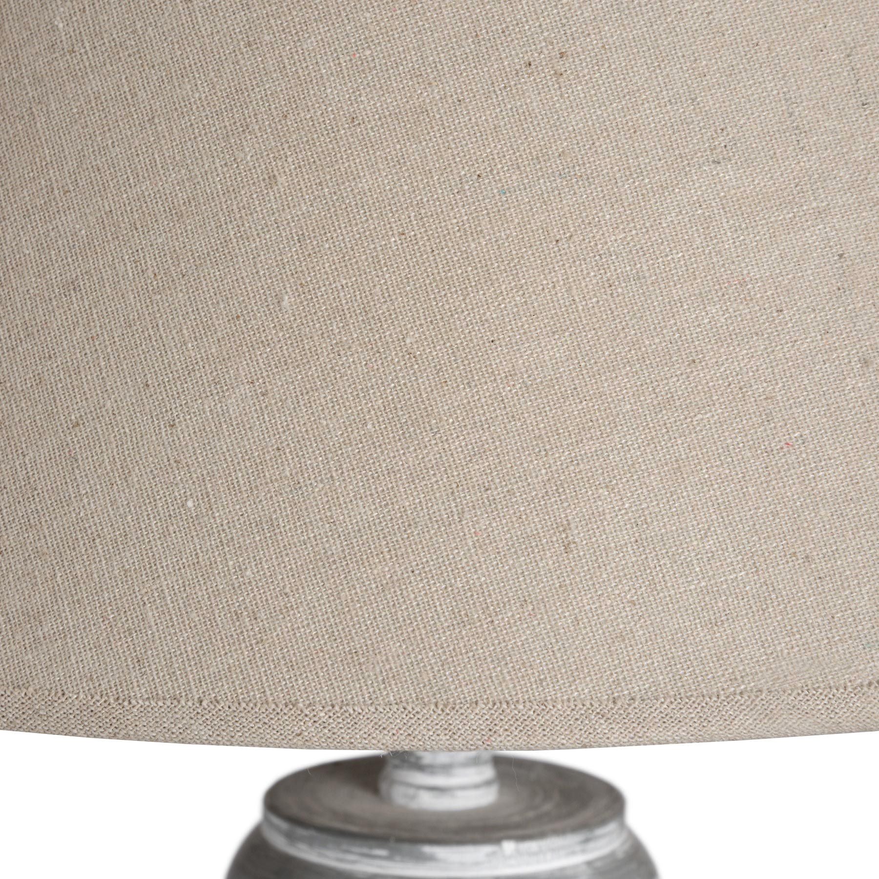 Grey and whitewashed floor lamp featuring a classic linen shade, showcasing intricate handcrafted detailing for an elegant ambiance.