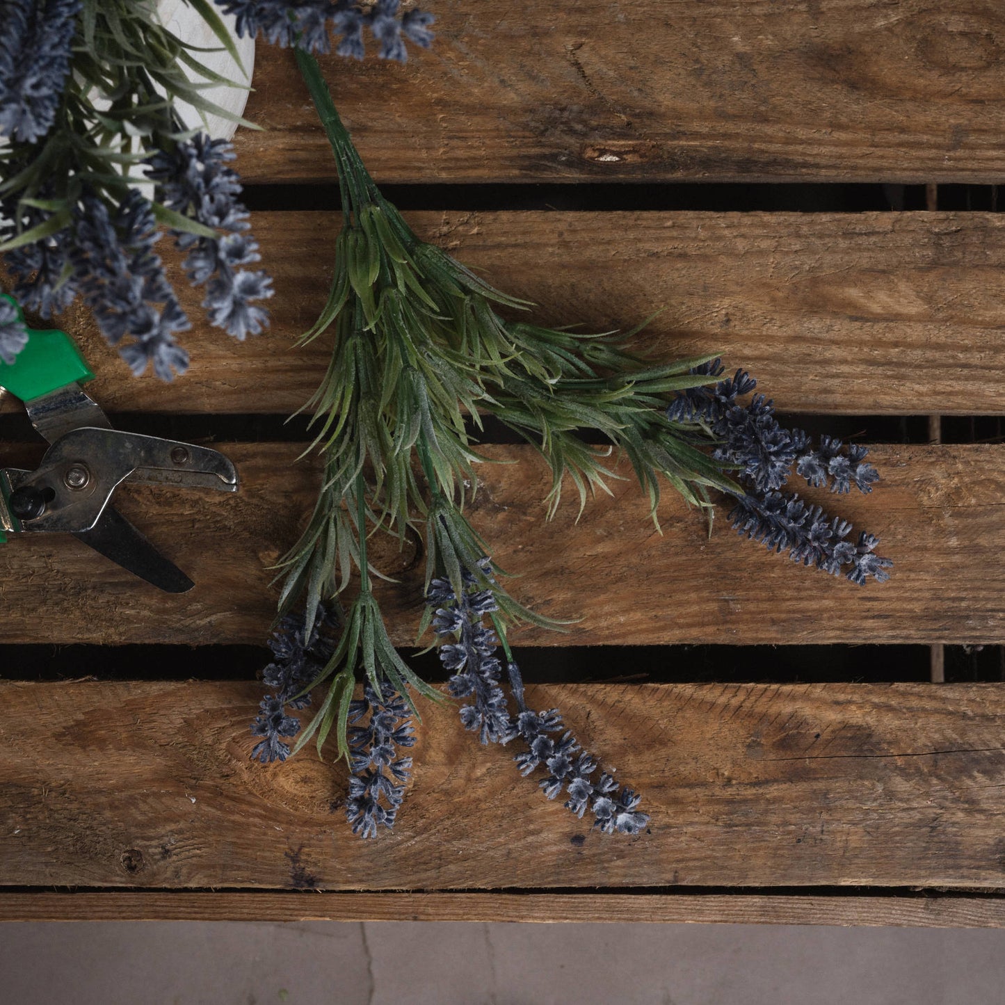 Realistic small lavender spray featuring delicate purple blooms and lush green foliage on a wooden surface. No maintenance needed.