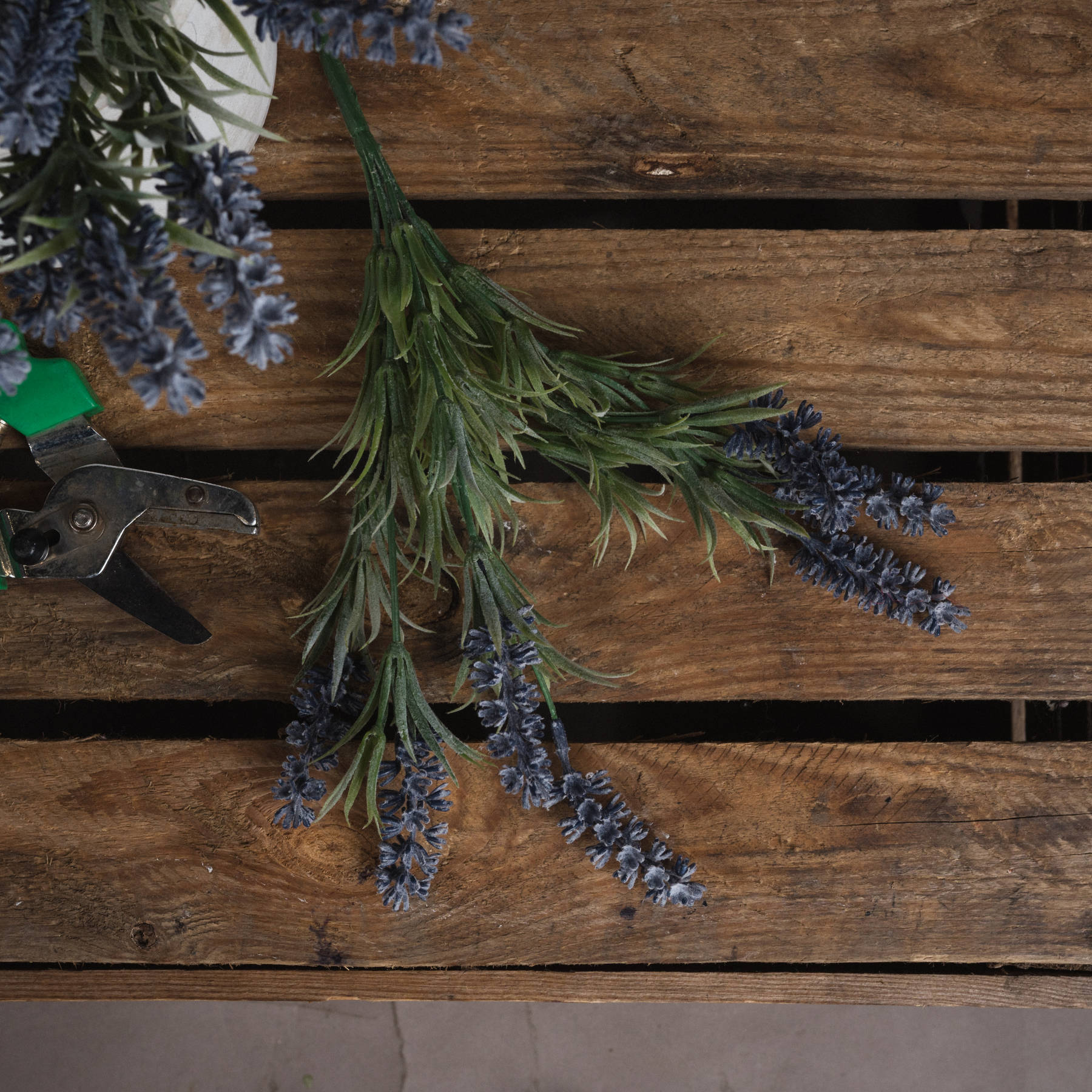 Realistic small lavender spray featuring delicate purple blooms and lush green foliage on a wooden surface. No maintenance needed.