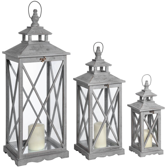 Three wooden lanterns in a rustic, gray finish feature a cross-section design and transparent panels, perfect for cozy decor.