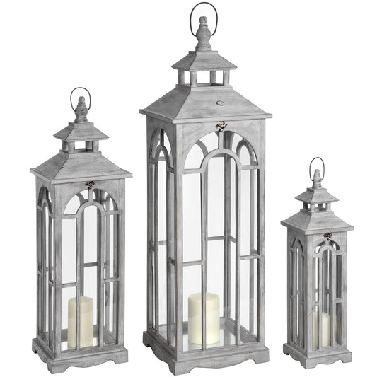 Set of three white-wash wooden lanterns featuring intricate archway designs, showcasing candles inside for a warm ambiance.