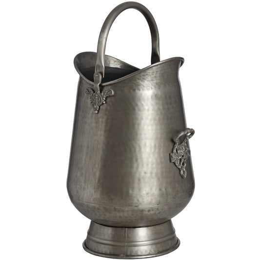 Antique pewter coal bucket with intricate leaf motifs, ornate handle, and a hammered finish, ideal for firewood or decor.