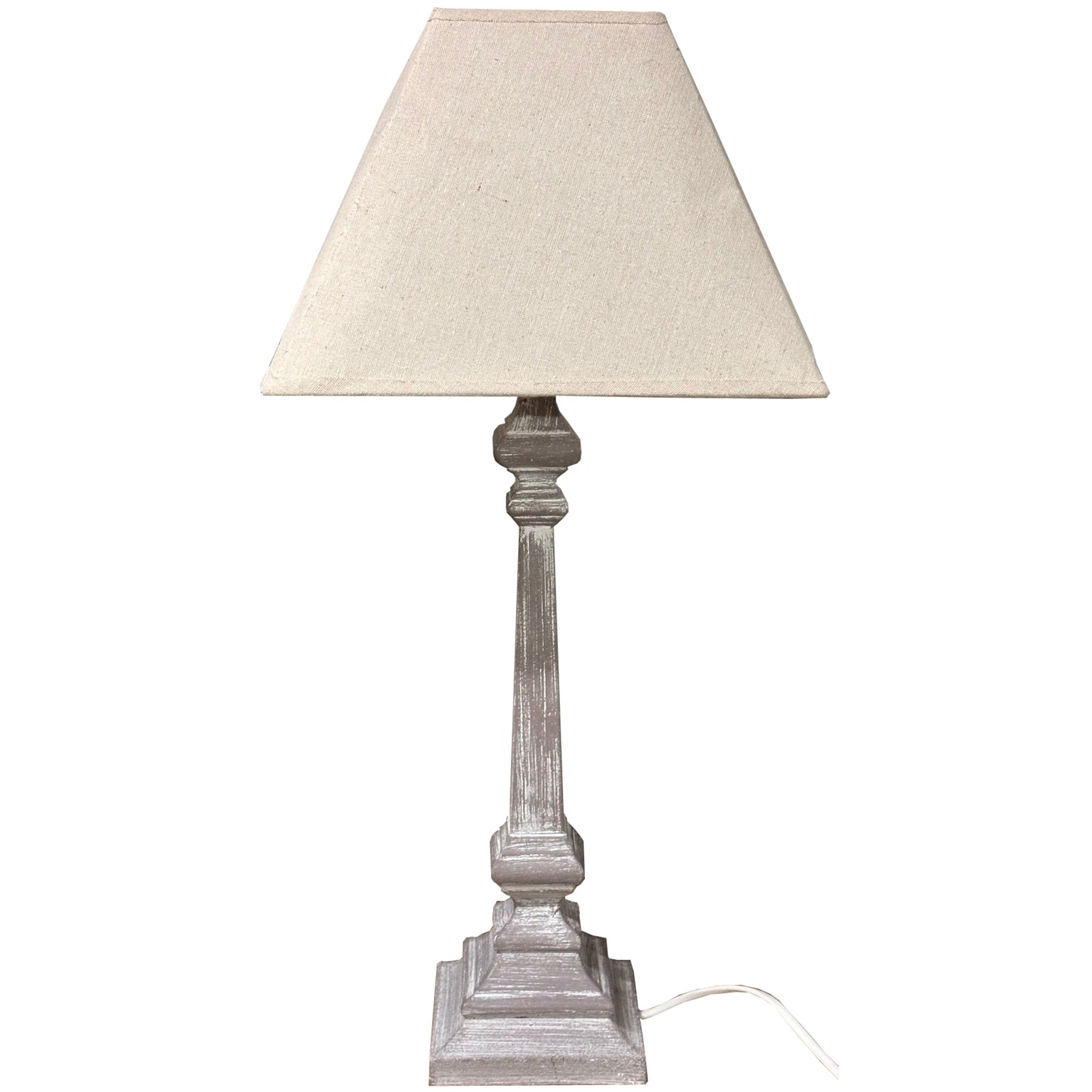 Elegant table lamp with a whitewashed wooden base and soft linen shade, perfect for creating a cozy atmosphere in rustic interiors.