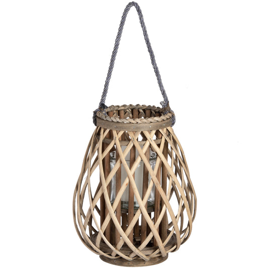 Bulbous wicker lantern with a natural organic texture, featuring intricate rattan weaving and a glass candle holder inside.
