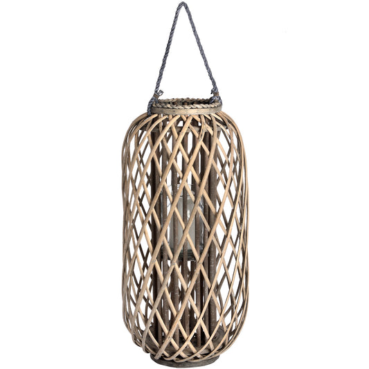 Large standing wicker lantern made of natural rattan, featuring a woven design that casts enchanting light patterns.