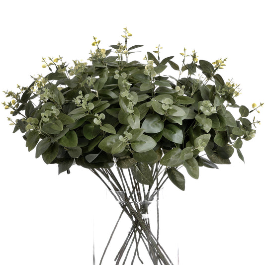 Lush dark green eucalyptus foliage with delicate floral accents, elegantly arranged in a short stem design for versatile decor.