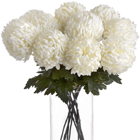 Lifelike large white chrysanthemums with intricate petals, nestled among green leaves in a clear vase, perfect for elegant decor.