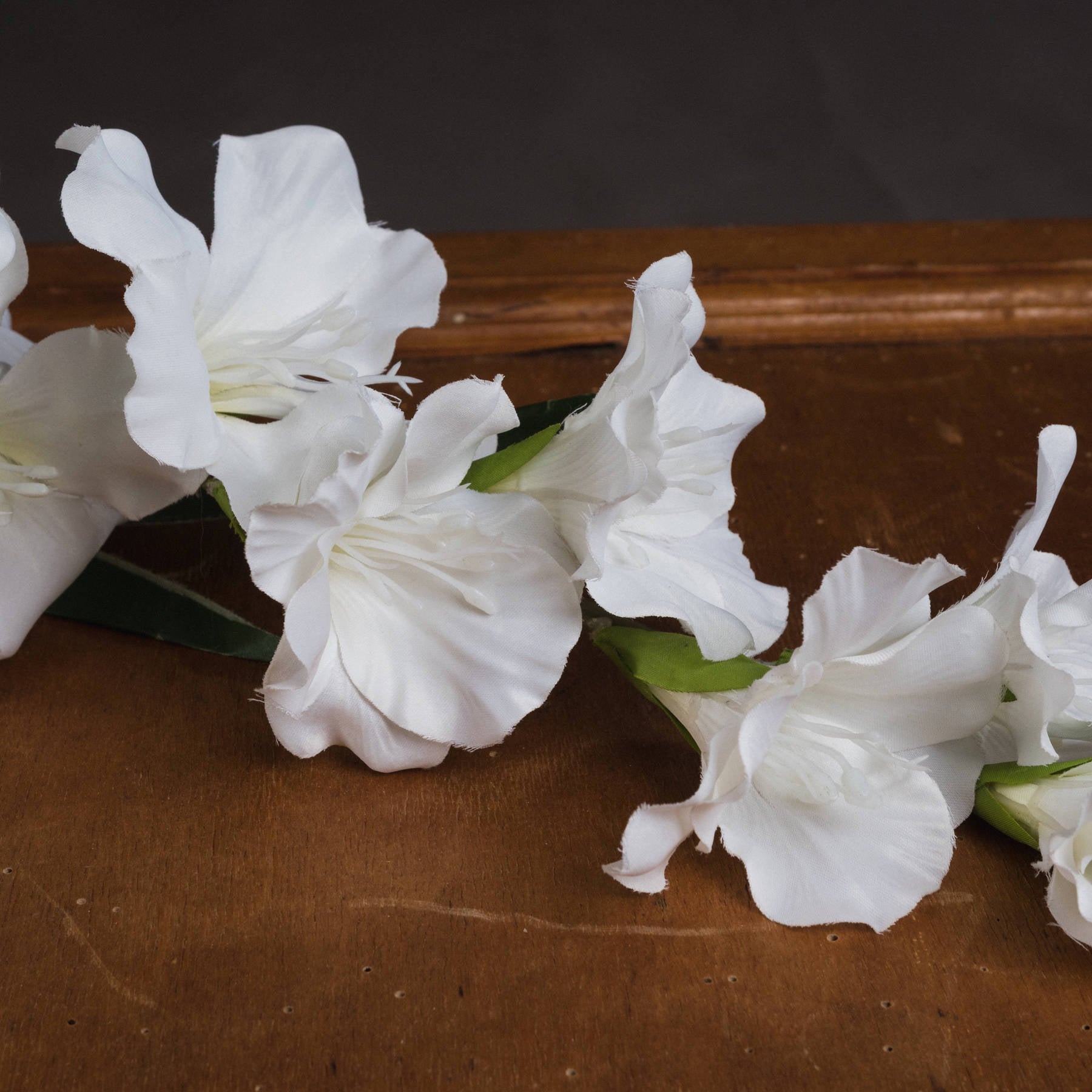 Elegant faux white gladioli with lifelike petals on slender stems, arranged perfectly for modern and traditional decor.
