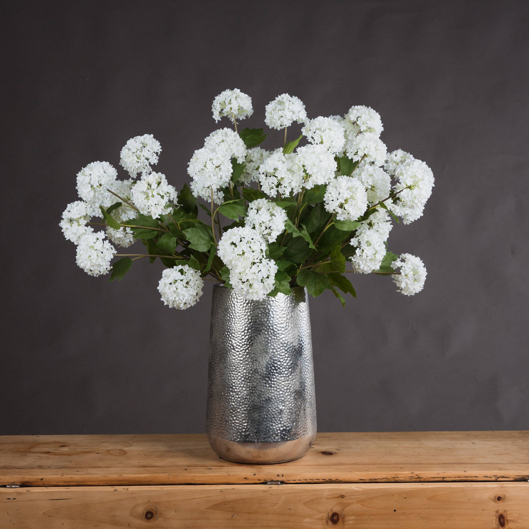 Lifelike white viburnum flowers in a silver textured vase, complementing modern and traditional decor with natural elegance.