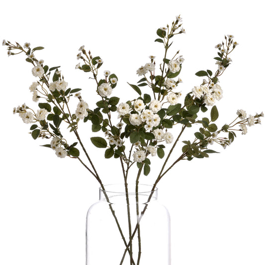 Elegant white faux wild meadow roses with delicate blooms and green leaves, arranged in a clear vase for a minimalist look.