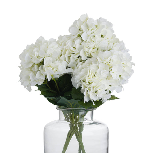 Lifelike white hydrangea bouquet with multiple bloom clusters, elegantly arranged in a clear glass vase, enhancing any decor.