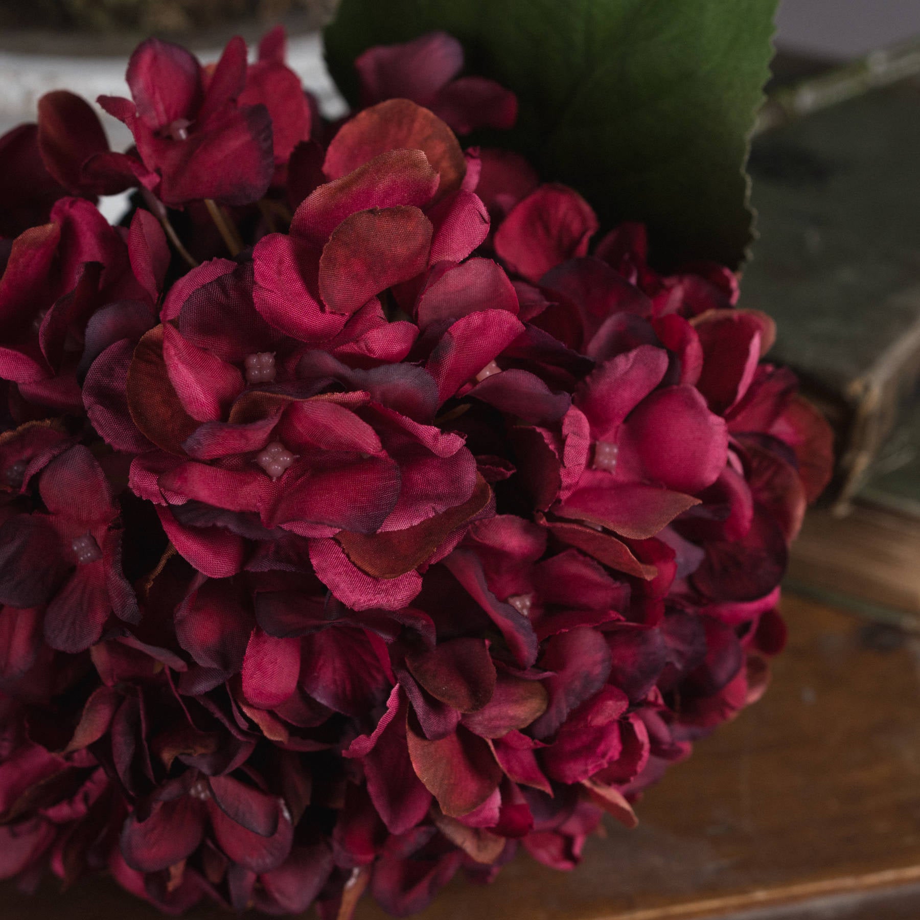 Lifelike autumn ruby hydrangea with deep red petals and rich textures, perfect for enhancing any elegant decor.