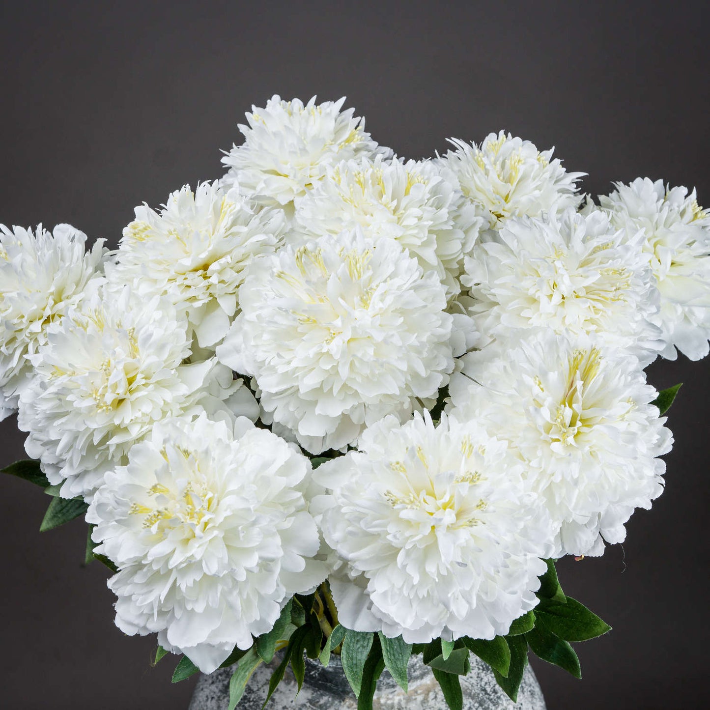 Meticulously crafted white peony blooms with intricate petals and greenery, perfect for elegant home decor.
