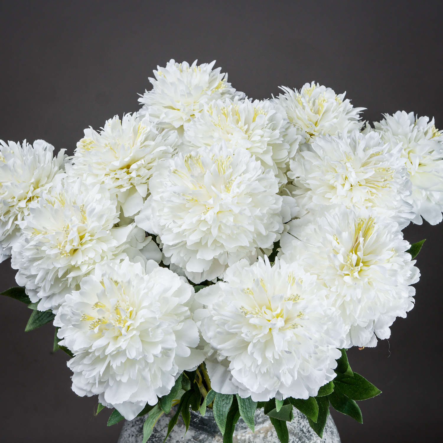 Meticulously crafted white peony blooms with intricate petals and greenery, perfect for elegant home decor.