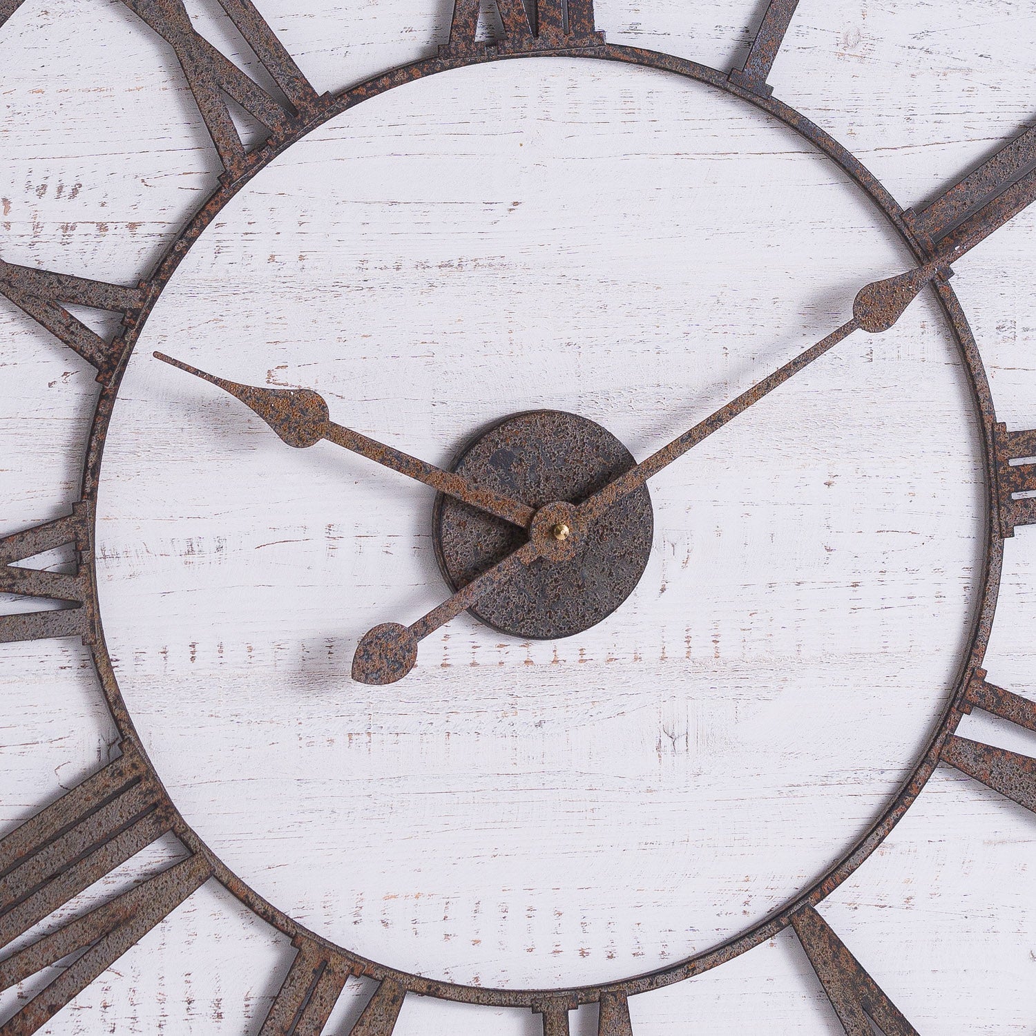 Rustic wall clock featuring aged numerals and hands on a whitewashed backboard, adding vintage charm to any space.