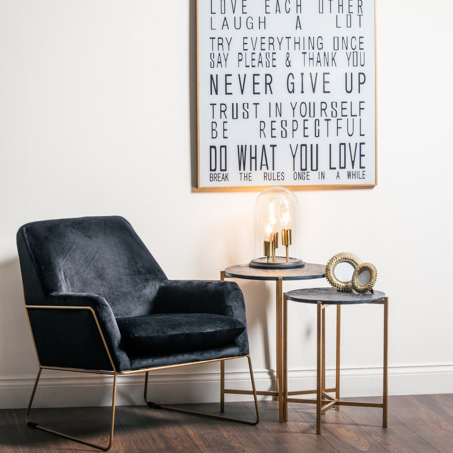 Set of two elegant side tables featuring rich black marble tops and gold metallic bases, ideal for modern or classic interiors.