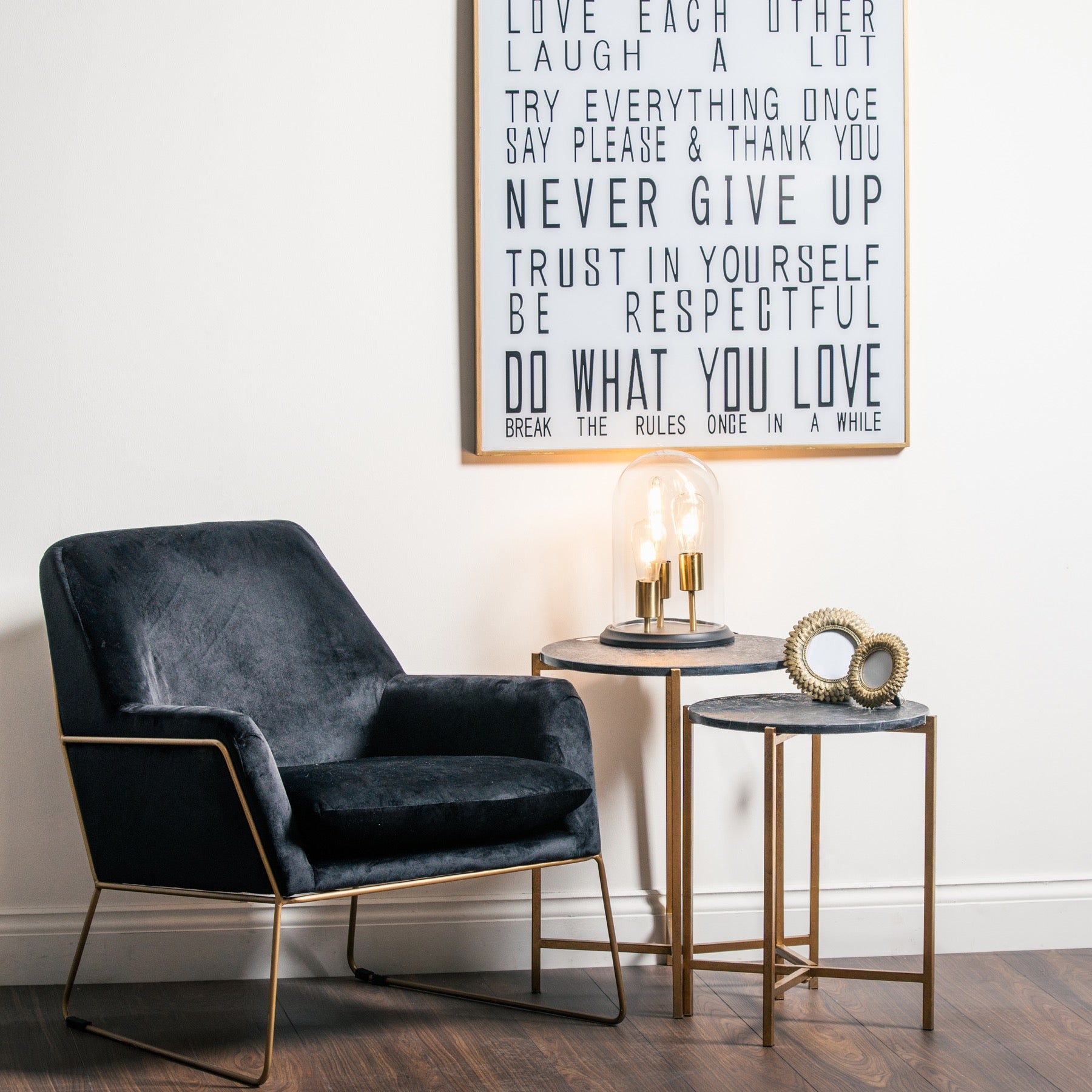 Set of two elegant side tables featuring rich black marble tops and gold metallic bases, ideal for modern or classic interiors.