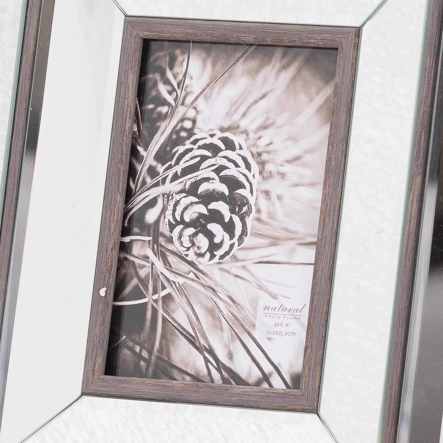 Red 4x6 photo frame with natural wood and beveled mirror edges, showcasing a black and white pinecone image, adding rustic elegance.